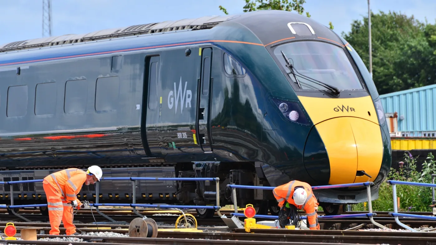 Engineers working on the track as a GWR train passes